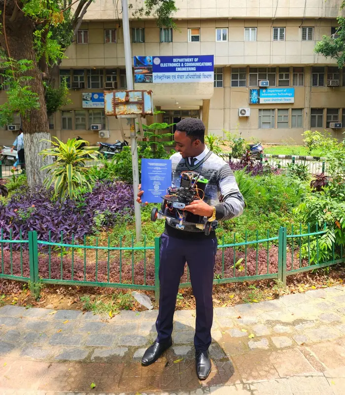 Holding EIRT and the project thesis outside the Electronics and Communications department · Oluwaferanmi Iyiola